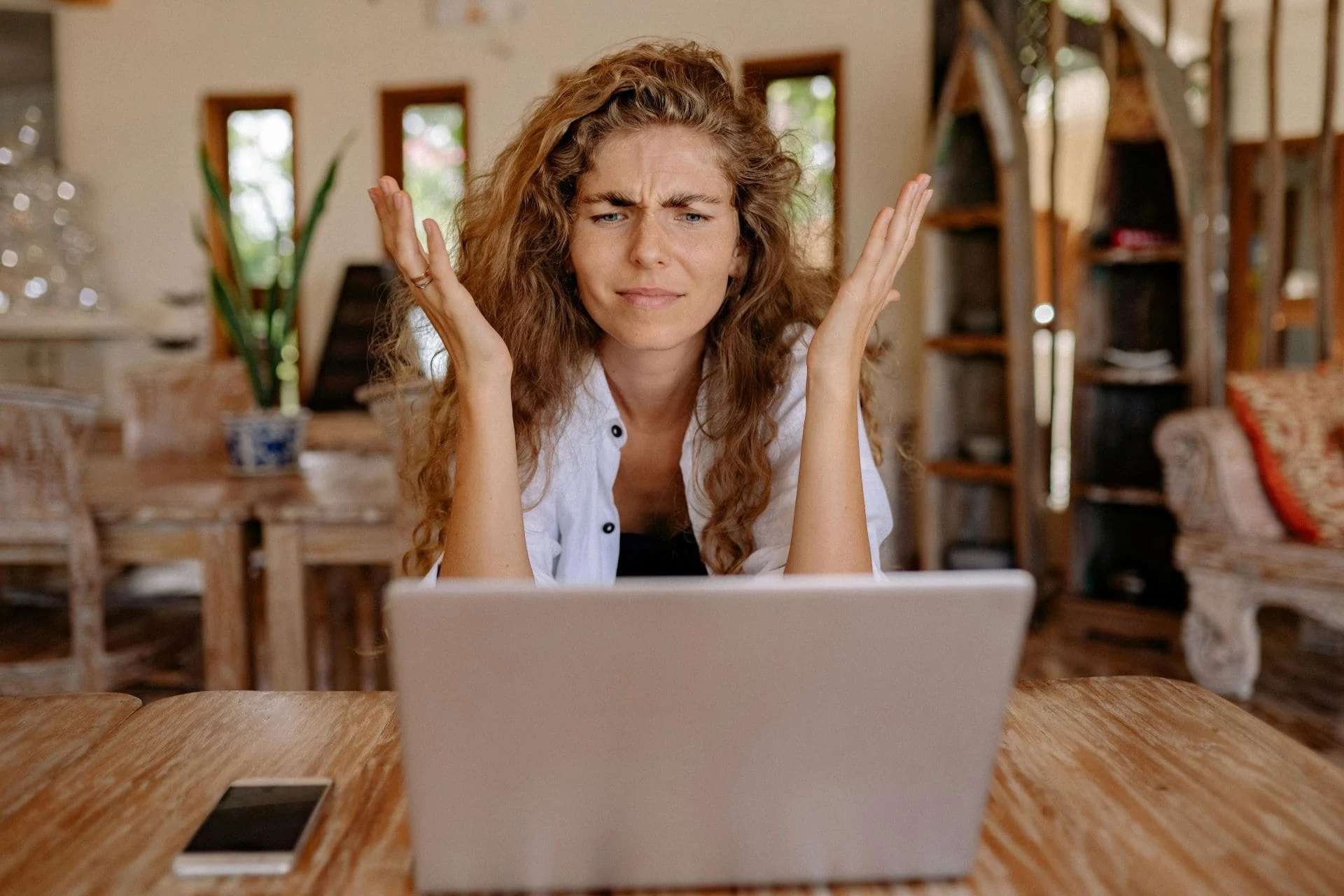 Person looking at laptop and confused